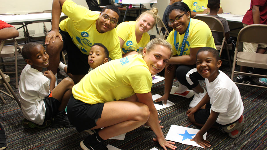 Central YMCA of Youngstown day camp counselors Bethany Haddle (front), Michael Stevens and Maddie Pacifico play Shapes and Colors Twister with teacher Chelsea Danielle and campers Jaream Rutlbeg, Dennis Brown and Kashmere Wolmack