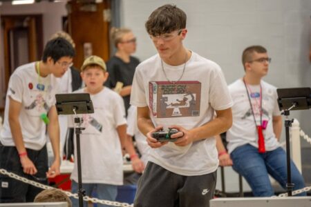 A student controls his teams' robot at Grove City College's BEST Robotics competition in October 2023.