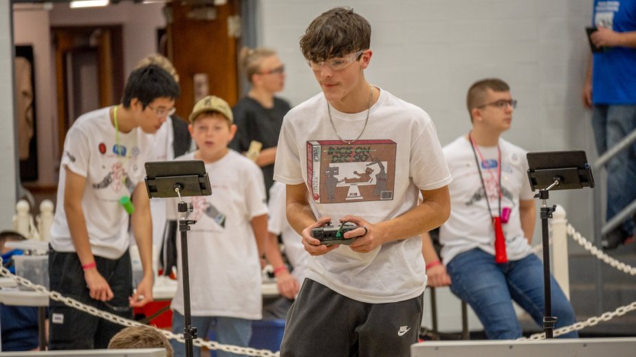 A student controls his teams' robot at Grove City College's BEST Robotics competition in October 2023.