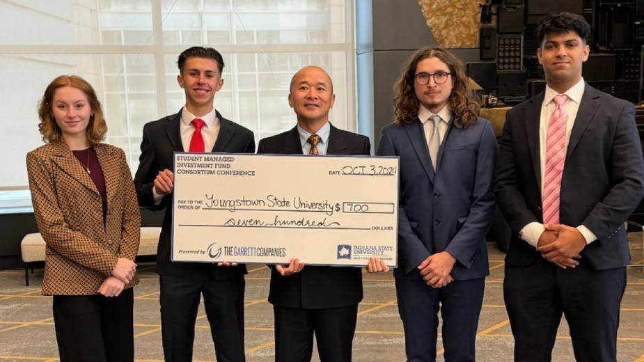 Alison Maring, James Kover, Simon Iwanonkiw, Zakria Chandio, all officers of the Student Investment Fund at Youngstown State University, and Peter Chen, associate professor in the Lariccia School of Accounting & Finance, faculty advisor (center), earned third place among 100 other universities in the Student Managed Investment Fund Consortium (SMIFC) held in Chicago, Illinois receiving $700.